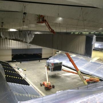 Masking all surfaces prior to coating the ceiling of Royal Farms Arena