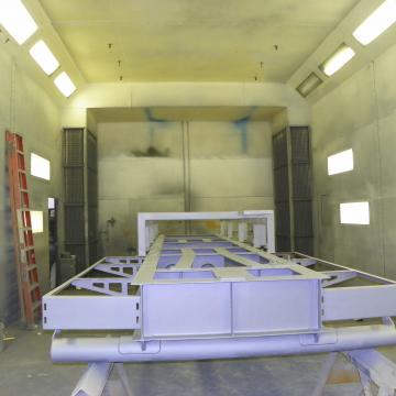 Priming Structural Steel in Paint Booth.