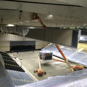 Masking all surfaces prior to coating the ceiling of Royal Farms Arena